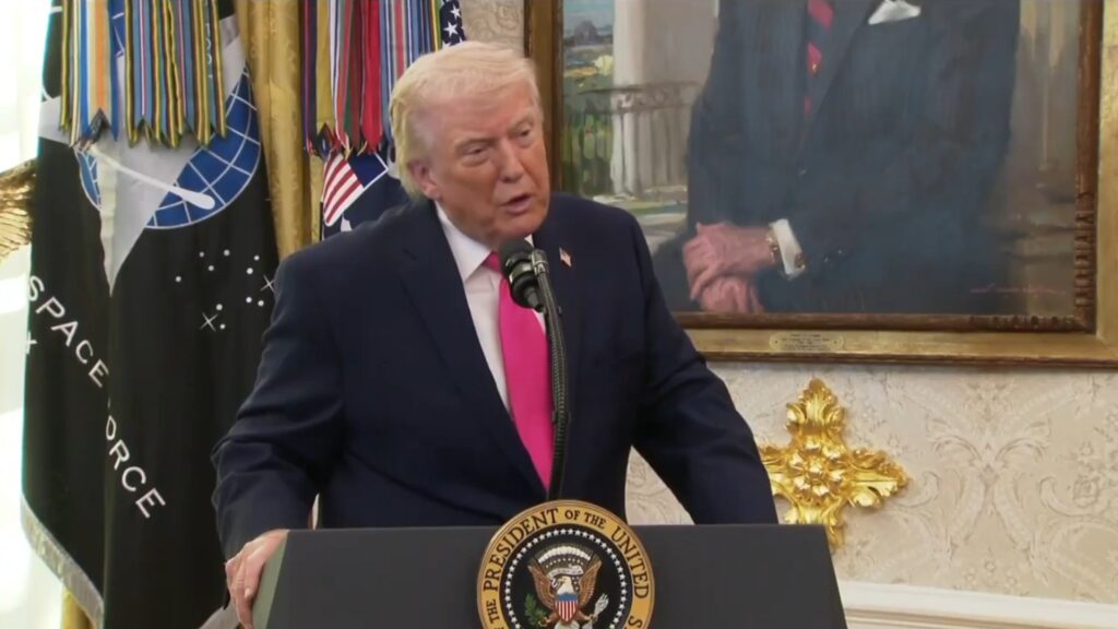President Trump standing behind podium