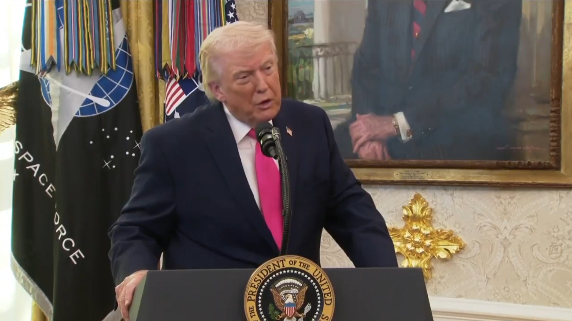 President Trump standing behind podium