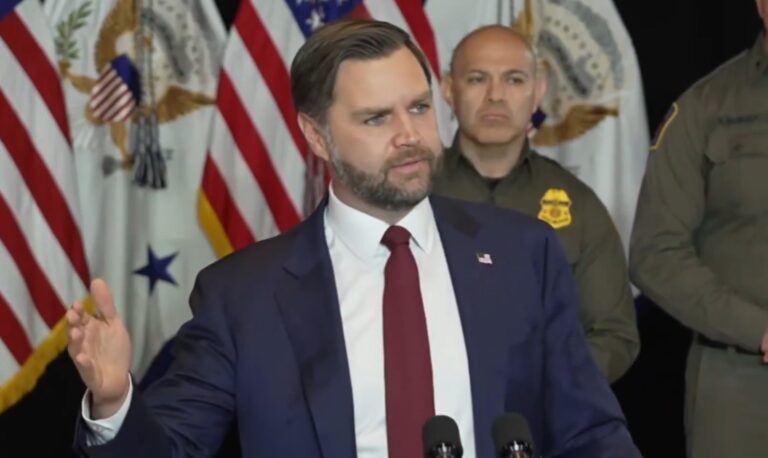 JD Vance standing during a speech