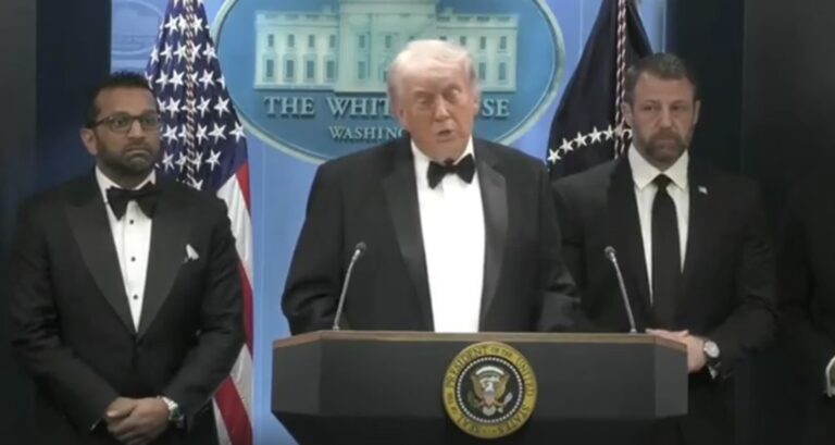 President Trump speaking with men standing nearby