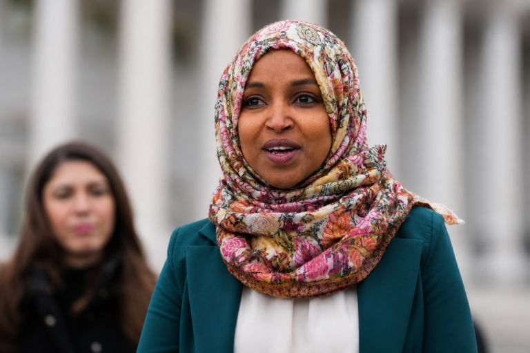 Ilhan Omar outside of a building speaking