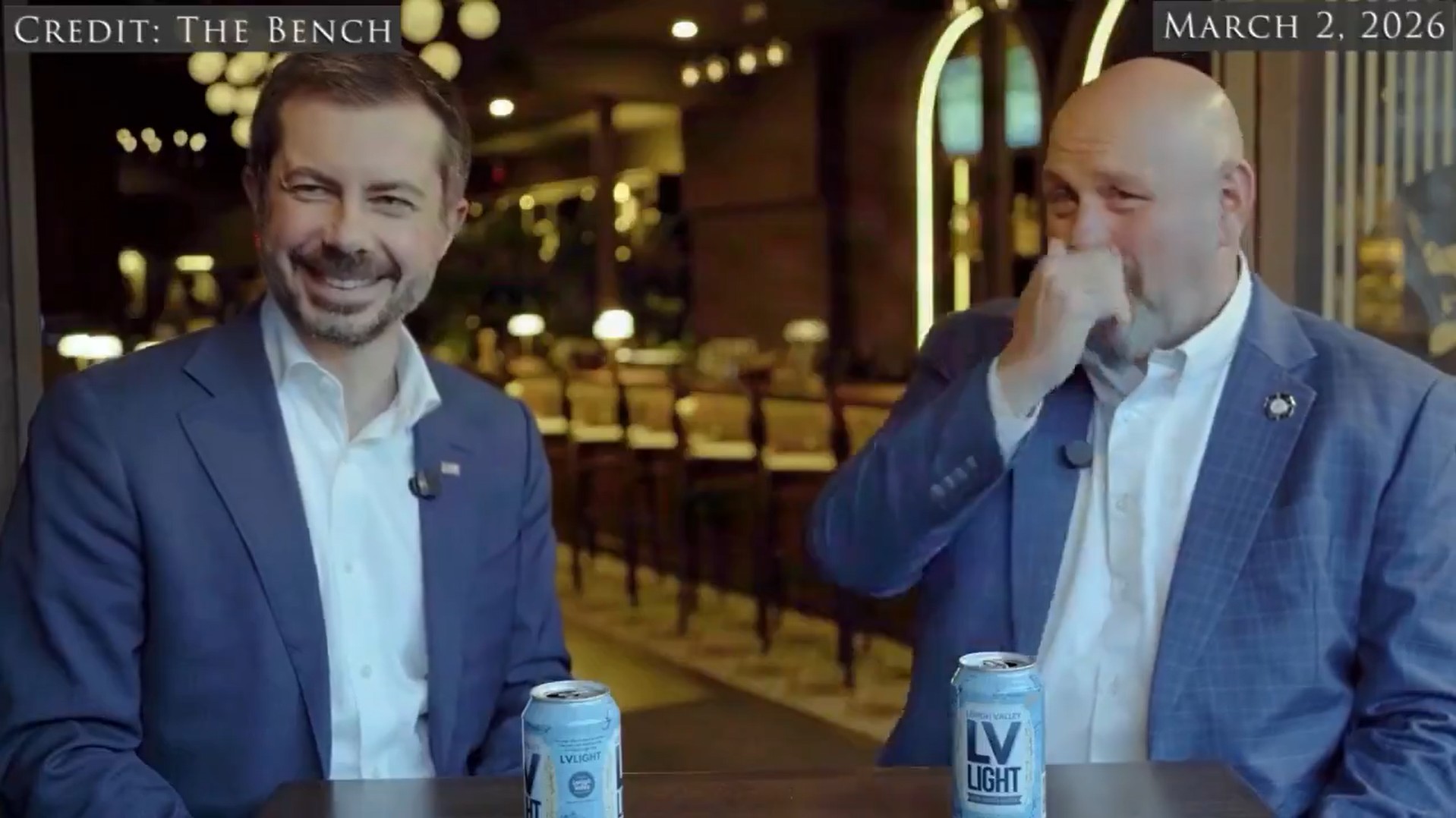Pete Buttigieg sitting at a table with another man