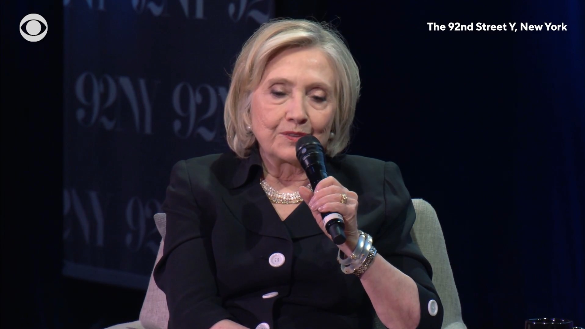 Hillary Clinton holding a microphone