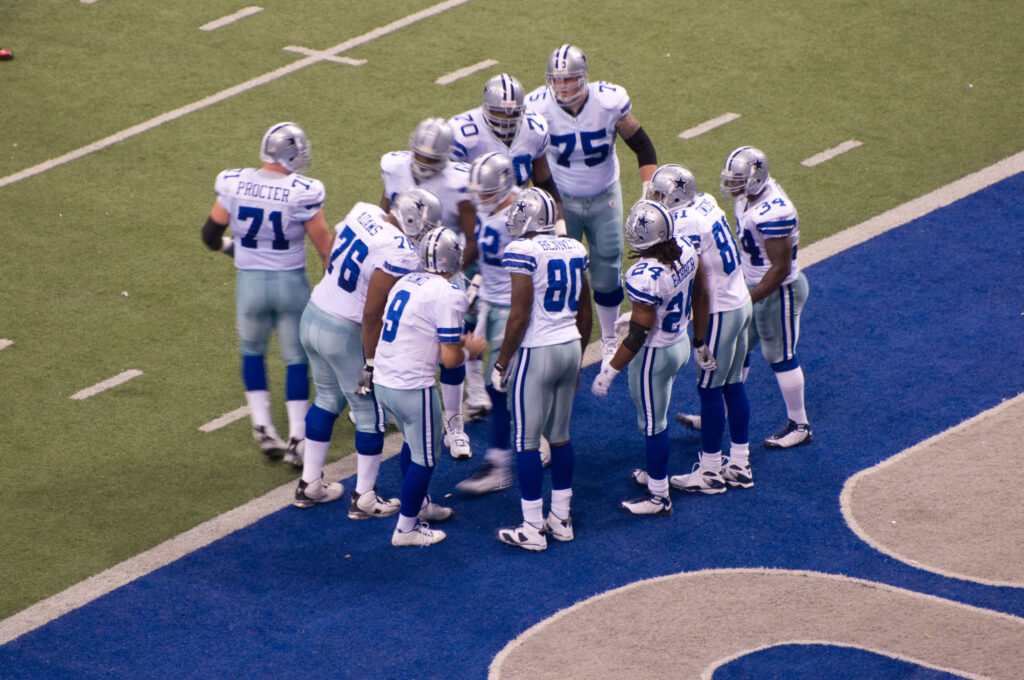 Dallas Cowboys football team in a huddle