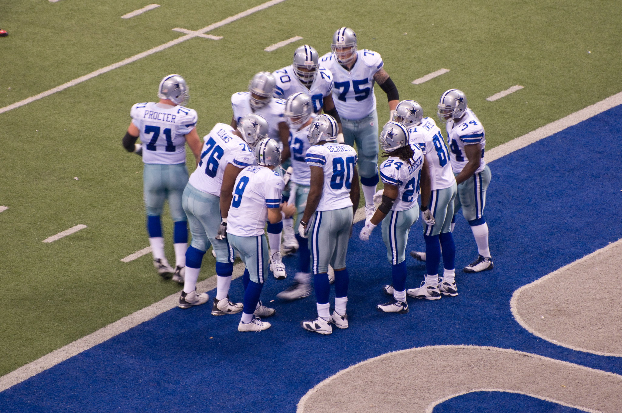 Dallas Cowboys football team in a huddle
