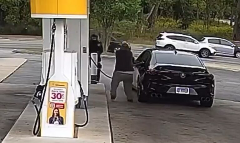Men at a gas station pump